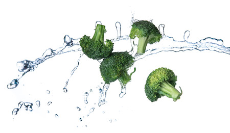 Broccoli with water splash or explosion flying in the air isolated on white backgroundの写真素材