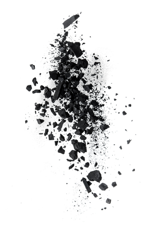 Activated charcoal powder splash or explosion flying in the air isolated on white backgroundの写真素材