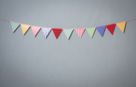Paper party flags for decoration and covering on grey concrete textured copy space backgroundの写真素材