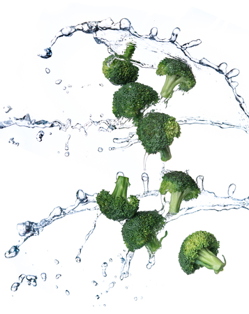 Broccoli with water splash or explosion flying in the air isolated on white backgroundの写真素材