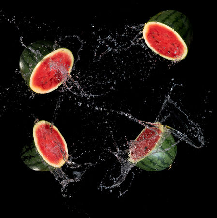 Sliced Watermelon with water splash flying in the air,Stop motionの写真素材