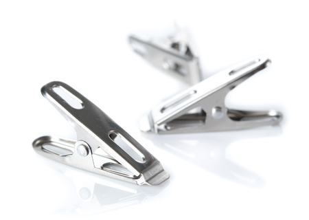 Steel clothespins clamp on white backgroundの写真素材