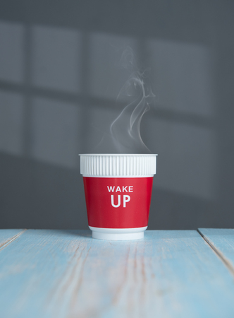 Wake up word with hot coffee drink in morning on grayの写真素材