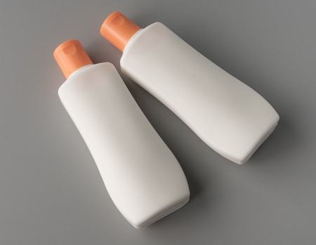White plastic for shampoo, shower gel, lotion bottle on grey background for print design and mock up