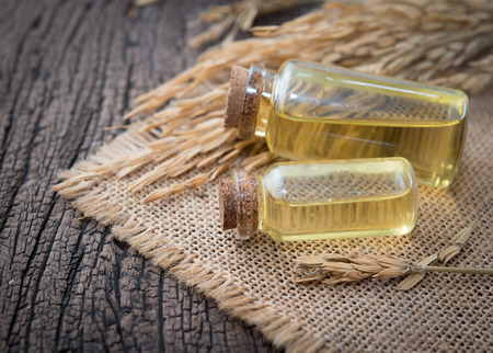 rice paddy with rice bran oil in glass bottle on wood backgroundの写真素材