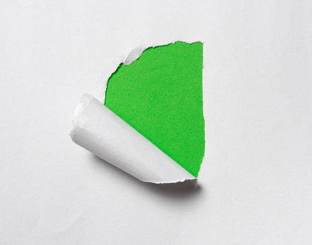 Hole in the paper with space for text on green backgroundの写真素材