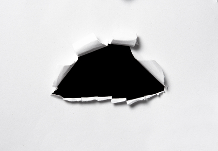 Hole in the paper with space for text with black backgroundの写真素材