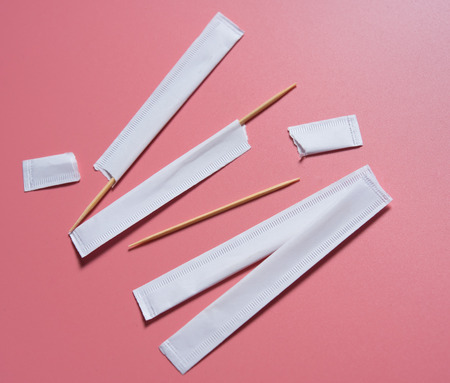 Toothpick packed in paper bag on pink Backgroundの写真素材