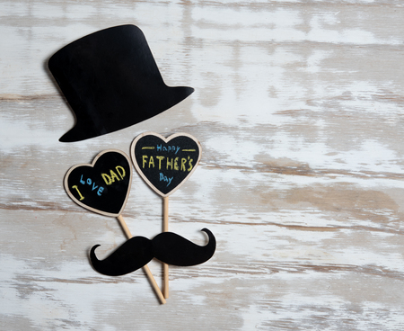 Happy Fathers Day concept,hat, black mustache with heart tag with Happy father's day text on wooden tableの写真素材