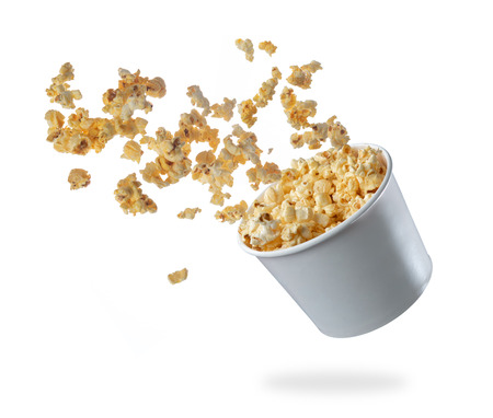Popcorn flying out of the package isolated on whiteの写真素材