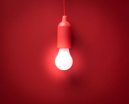 Light bulb on red backgroundの写真素材