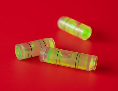 Green bubble level on red background
