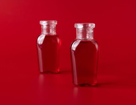 Shampoo and shower gel against red backgroundの写真素材