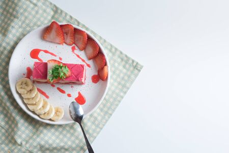 layered strawberry cake with slice of banana and strawberryの写真素材