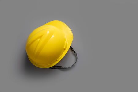Yellow safety helmet construction on gray background,top viewの写真素材