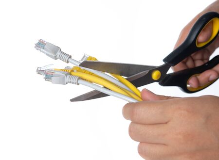Scissors cutting the network cable on white backgrund
