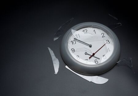 Broken wall clock on dark background,destroyed clockの写真素材