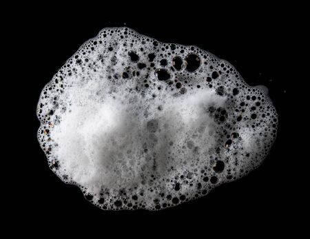 Soap foam Shaving cream bubble isolated on black backgroundの写真素材