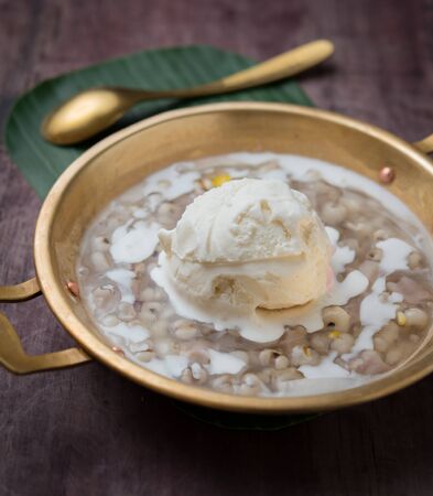 Coconut milk ice cream on brass blow with Thai Dessertsの写真素材