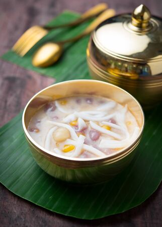 Bua loi,Colorful rainbow Thai glutinous rice balls with coconut milk on wood,Thai dessertの写真素材