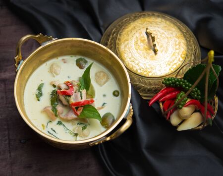 Chicken green curry, creamy soup, with eggplant on wood table,Thai foodの写真素材