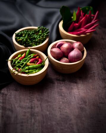 Pepper, chilli, red onion in bowl on wood table,thai kitchen food spice herbの写真素材