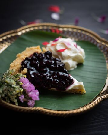 Piece of blueberry cheesecake on wooden tableの写真素材