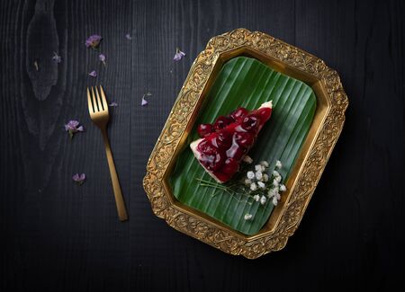 Piece of berry cheesecake  on wooden tableの写真素材