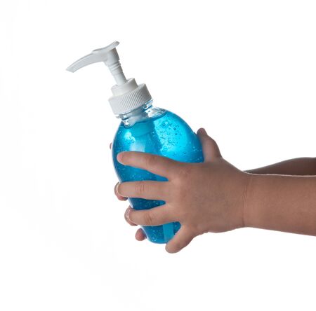 Small kid hands holding bottle of hand sanitizer, antimicrobial liquid gel isolated on white backgroundの写真素材