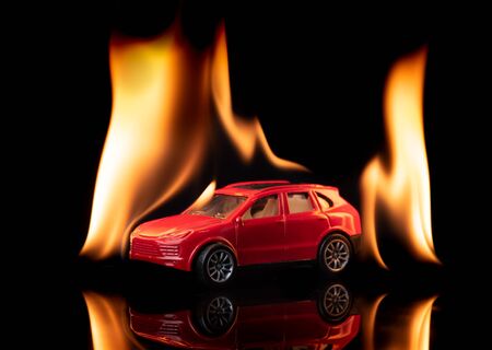 Burning car toy on black background,Car on fireの写真素材