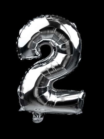 Letter 2 of silver balloons isolated on black background