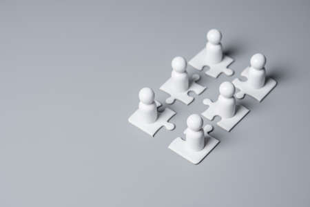 Wooden people standing on puzzles ,human resources and management concept,teamworkの写真素材