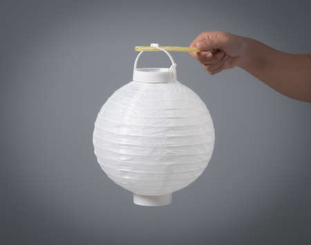 Hand holding white paper lantern traditional japanese