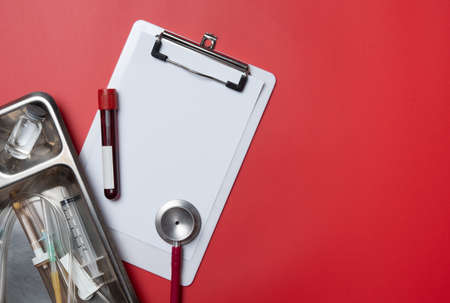 Healthcare concept : Stethoscope, tube of blood and blank medical clipboardの写真素材