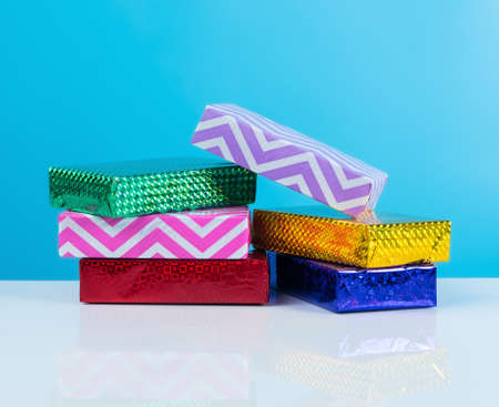 Gift box on white table,blue background