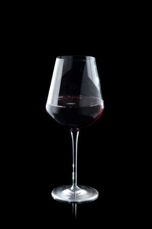 Glass of red wine on the black backgroundの写真素材