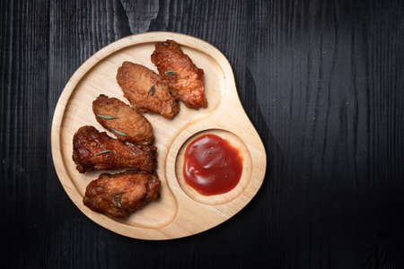 Baked chicken wings and chili sauce on the tableの写真素材