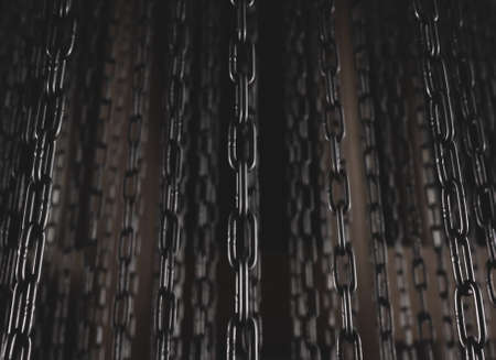 Metallic chains hanging against dark background