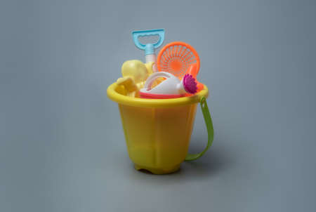 Beach toys: children's sea bucket for playing in the sand on gray background.の写真素材