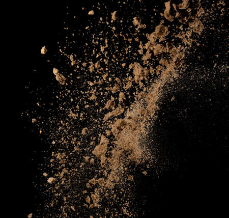 Sandy explosion isolated on over dark background,Abstract sand cloud,Motion blurの写真素材
