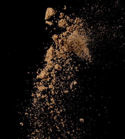 Sandy explosion isolated on over dark background,Abstract sand cloud,Motion blurの写真素材