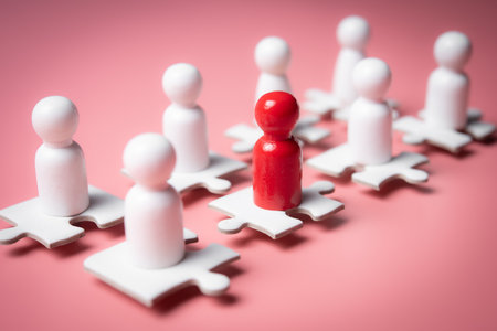 People figures on puzzles on pink background,human resources and management concept