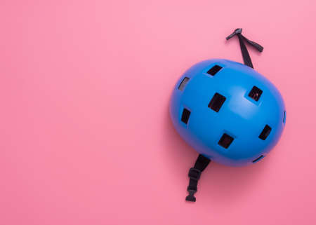 blue bike helmet on pink backgroundの写真素材