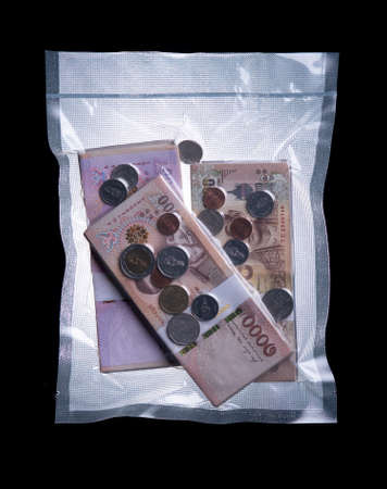 Money and coins in vacuum transparent plastic packaging,Saving money concept.