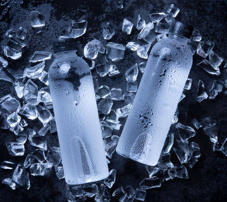 Water bottle is cooling on the ice cube,wood backgroundの写真素材