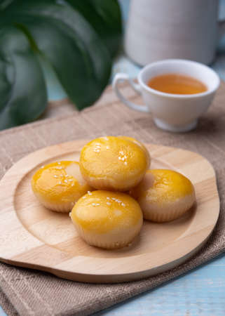 Chinese pastry puff, Beans cake with salted egg yolk lay on table woodの写真素材