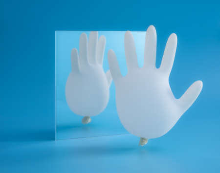Funny white glove on blue background with copy space,medical glove balloonの写真素材