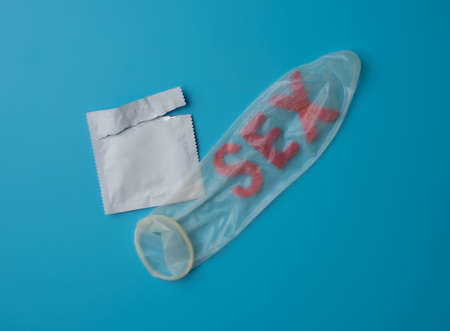 The word sex in condom on blue backgrund,Save sex concept.の写真素材