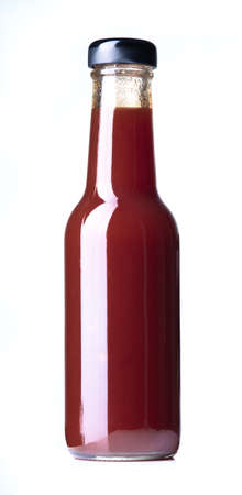 Glass bottle of ketchup on white background