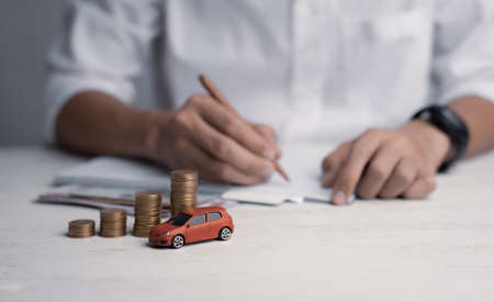 Coins stacking on desk,saving money for a car concept.の写真素材